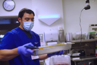 Food service professional from Sutter Health demonstrates how to prepare food for donation