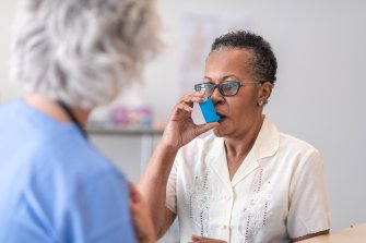 Woman uses inhaler